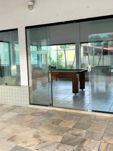 a pool table in a room with glass walls at Casa Quinta do Atlântico - Aconchego da Paz 150m da praia in Búzios +60 photos