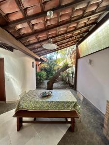 a patio with a table with a bowl on it at Casa Quinta do Atlântico - Aconchego da Paz 150m da praia in Búzios