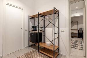 a room with a shelf with a coffee maker at Ai Vicoli Ciambra's Alley by Wonderful Italy in Monreale