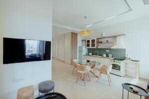 a kitchen and dining room with a glass table and chairs at SEMIRAMIS Luxury Apartments in Poros