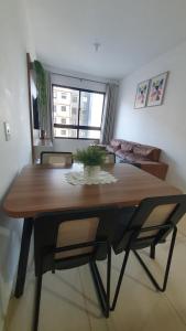 a dining room with a wooden table and chairs at Apto condomínio conforto e ótima localização in Lucas do Rio Verde