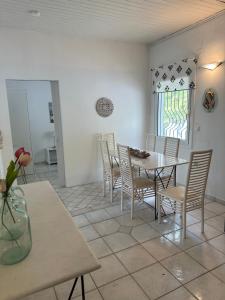a dining room with a table and chairs and a window at Villa Penelope in Corfu