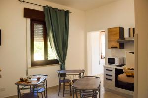 a kitchen with a table and chairs in a room at Sorsi di Sicilia in Ballata
