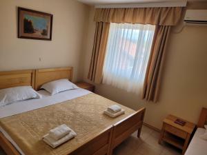 Postel nebo postele na pokoji v ubytování Hotel Alfa