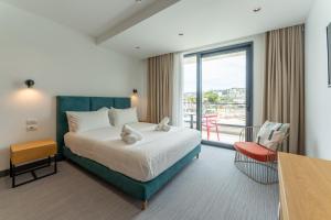 a hotel room with a bed and a balcony at Manta Hotel in Ksamil