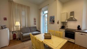 a kitchen and living room with a table and a couch at Villa dei Limoni in San Vincenzo