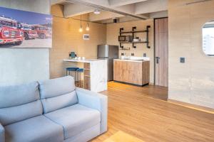 a living room with a couch and a kitchen at Loft 43 in Medellín