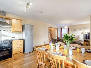a kitchen and dining room with a table and chairs at 3 Bed in Duddon Valley 89417 in Ulpha +16 photos