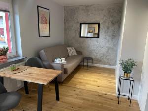 a living room with a couch and a table at GREY PEPPER with balcony in Siedlce +9 photos