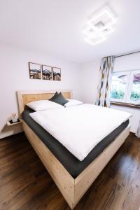 łóżko z drewnianą ramą w sypialni w obiekcie Haus Johannishof w mieście Mittenwald
