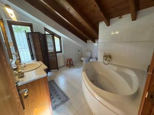 a bathroom with a large tub and a sink at Casa de Robles Cantabria, en el corazón de los Valles Pasiegos in Sel de la Carrera +47 photos