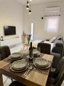 a living room with a table with plates on it at Modern Brand-New Apartment in Makarska