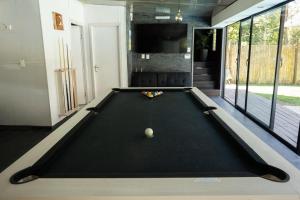 a pool table in the middle of a room at Destino Fortín in Villa Argentina +62 photos
