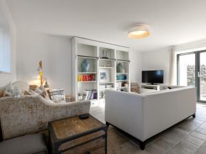 a living room with a white couch and a tv at 2 Bed in Cemaes Bay 77640 in Llanfechell