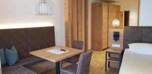 a dining room with a table and a bed at Hotel Restaurant Schaurhof in Vipiteno +76 photos