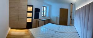 a bedroom with a white bed in a room at Hotel Restaurant Schaurhof in Vipiteno