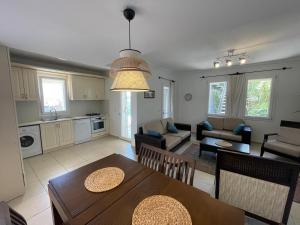 a kitchen and living room with a table and chairs at Monix Homes-Villa Magic Garden in Kaş