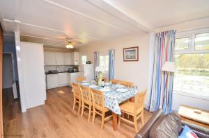 a kitchen and dining room with a table and chairs at Bittern - Horning holiday home in Horning +8 photos