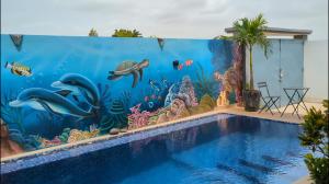 a swimming pool with a mural of an aquarium at Villa Hawa, Décor unique & Piscine in Somone