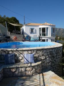 eine Villa mit Swimmingpool und ein Haus in der Unterkunft Villa Petros, Vassiliki, Lefkada - 3 bedrooms, pool, stunning views in Póndi