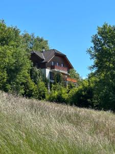 a house sitting on top of a hill at Villa Sara - Wörtherseeblick, Skifahren, Sauna in Sankt Bartlmä