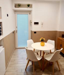 a dining room with a white table and chairs at Casa Giannina in Germignaga