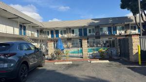 a car parked in front of a building with a pool at Studio 6 Corona, CA West in Corona