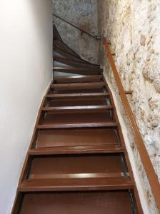 a set of stairs in a room with a stone wall at Old town - Fortezza Nest in Rethymno Town +27 photos