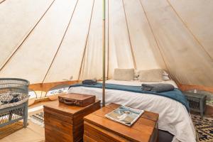 a bedroom with a bed in a tent at Zen Valley Glamping in Plettenberg Bay