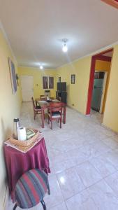 a living room with a table and chairs in it at Departamento la India 1 Temporario in San Fernando del Valle de Catamarca