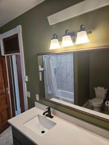 a bathroom with a sink and a large mirror at Albany Merchants Hotel in Albany +54 photos