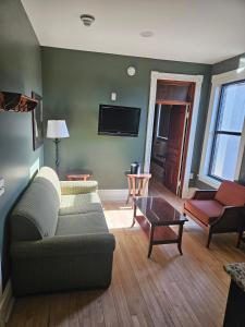 a living room with a couch and a table at Albany Merchants Hotel in Albany +46 photos