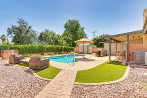 a backyard with a pool with a table and chairs at 3 Mi to Dtwn Shops and Eats Mesa Home with Pool! in Mesa