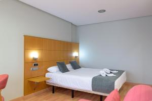 Postel nebo postele na pokoji v ubytování Hotel Alda Xinzo