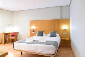 Postel nebo postele na pokoji v ubytování Hotel Alda Xinzo