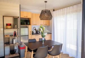a kitchen with a table with chairs and a vase of flowers at Eco Lodge Chamarel in Chamarel