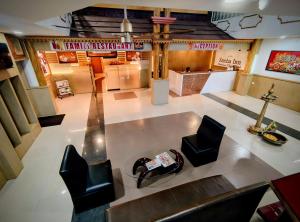 an overhead view of a lobby with chairs and a table at Sneha Inn in Kannur