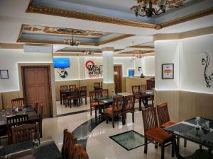 a dining room with tables and chairs in a restaurant at Sneha Inn in Kannur