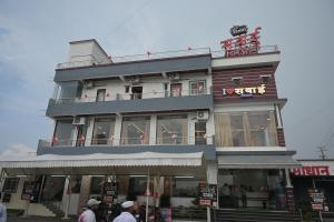 a building with people walking in front of it at Hotel Sawai Executive Branch 3 in Sāsvad