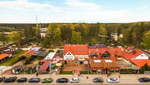 an aerial view of a town with cars parked in a parking lot at Pokoje Gościnne Ruciane-Nida in Ruciane-Nida