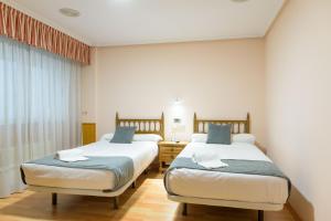 Postel nebo postele na pokoji v ubytování Hotel Alda Xinzo