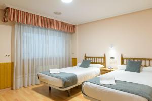 Postel nebo postele na pokoji v ubytování Hotel Alda Xinzo