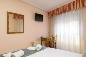 Postel nebo postele na pokoji v ubytování Hotel Alda Xinzo