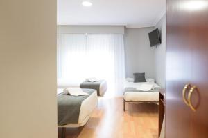 Postel nebo postele na pokoji v ubytování Hotel Alda Xinzo