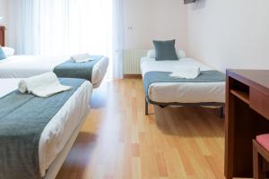 Postel nebo postele na pokoji v ubytování Hotel Alda Xinzo