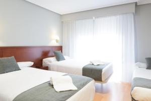 Postel nebo postele na pokoji v ubytování Hotel Alda Xinzo
