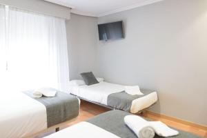 Postel nebo postele na pokoji v ubytování Hotel Alda Xinzo
