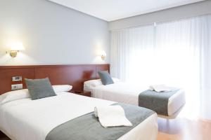 Postel nebo postele na pokoji v ubytování Hotel Alda Xinzo