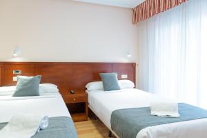 Postel nebo postele na pokoji v ubytování Hotel Alda Xinzo