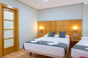 Postel nebo postele na pokoji v ubytování Hotel Alda Xinzo